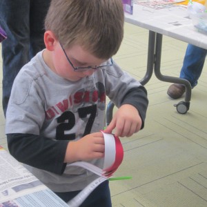 Portland Public Library, Maine; making a moon lantern with paper strips and a straw